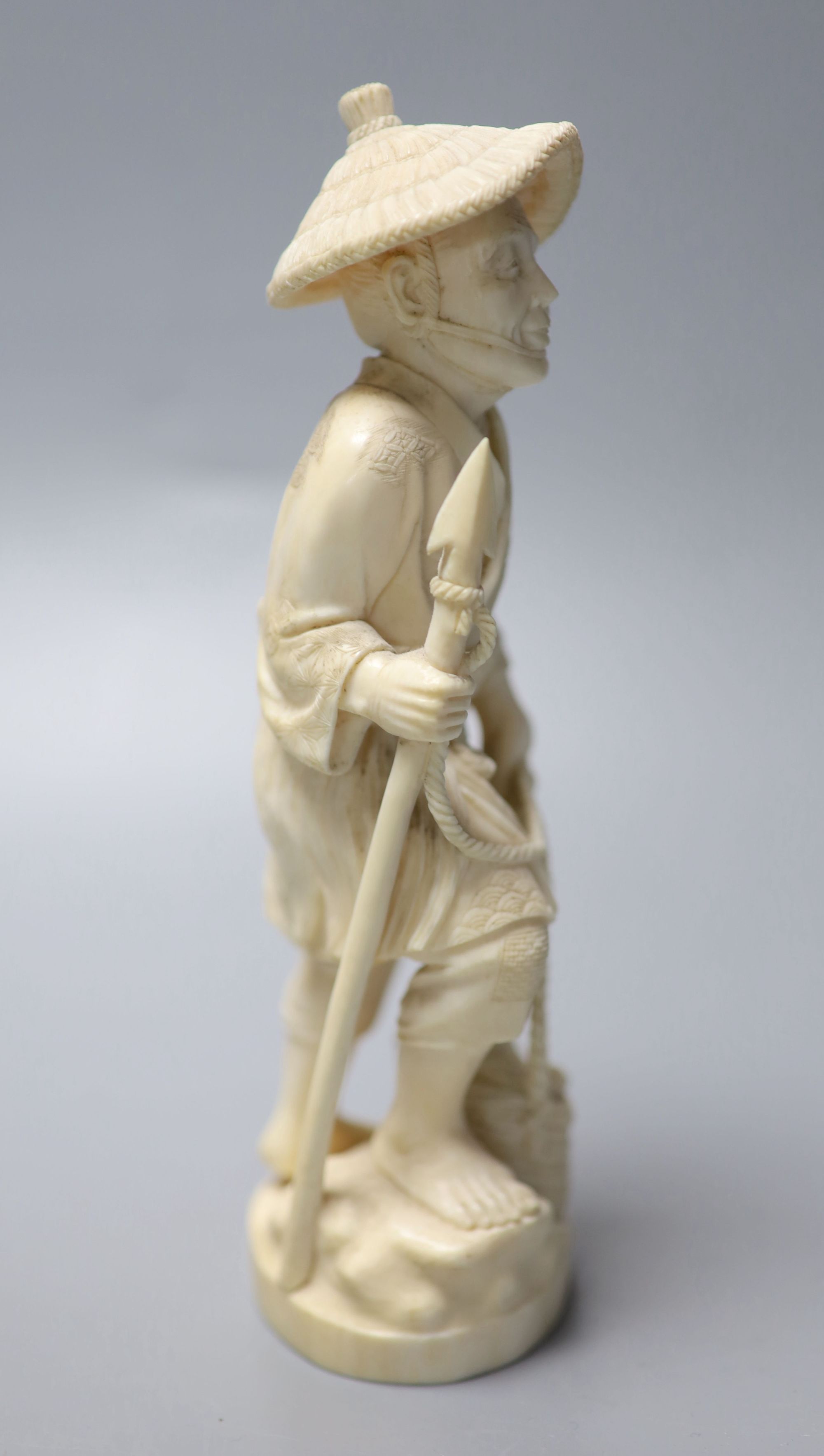 A Japanese Meiji period carved ivory figure of a fisherman, height 20cm